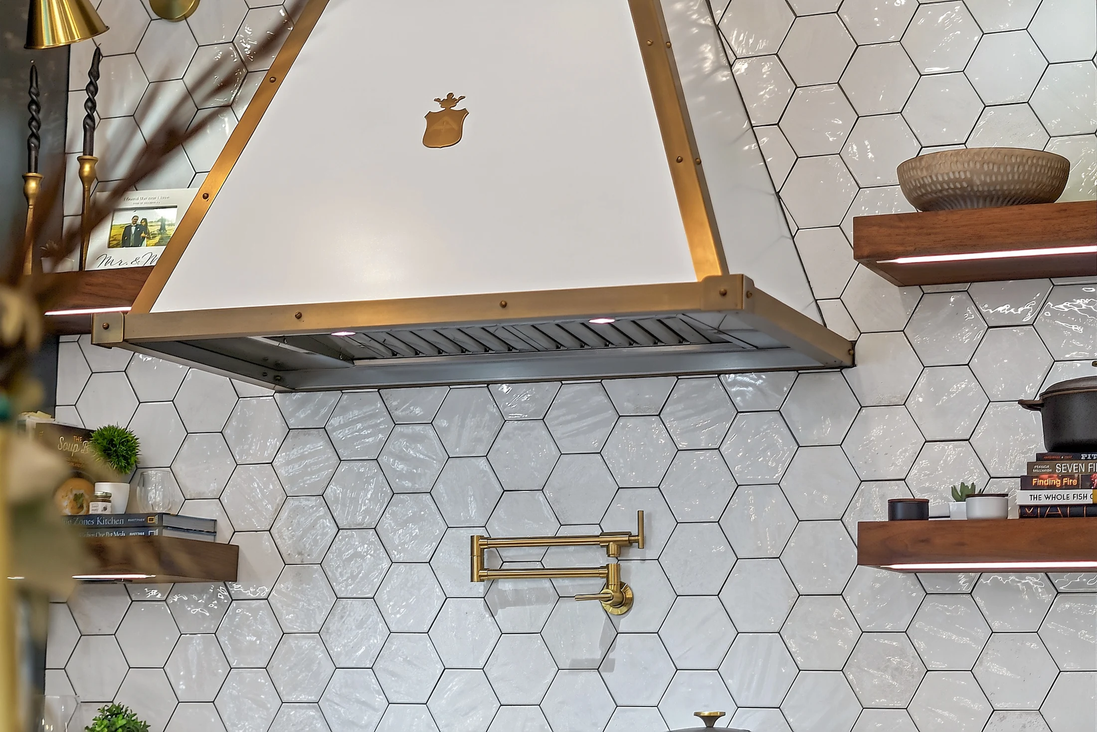 The Officine Gullo hood with white finish and brass trim