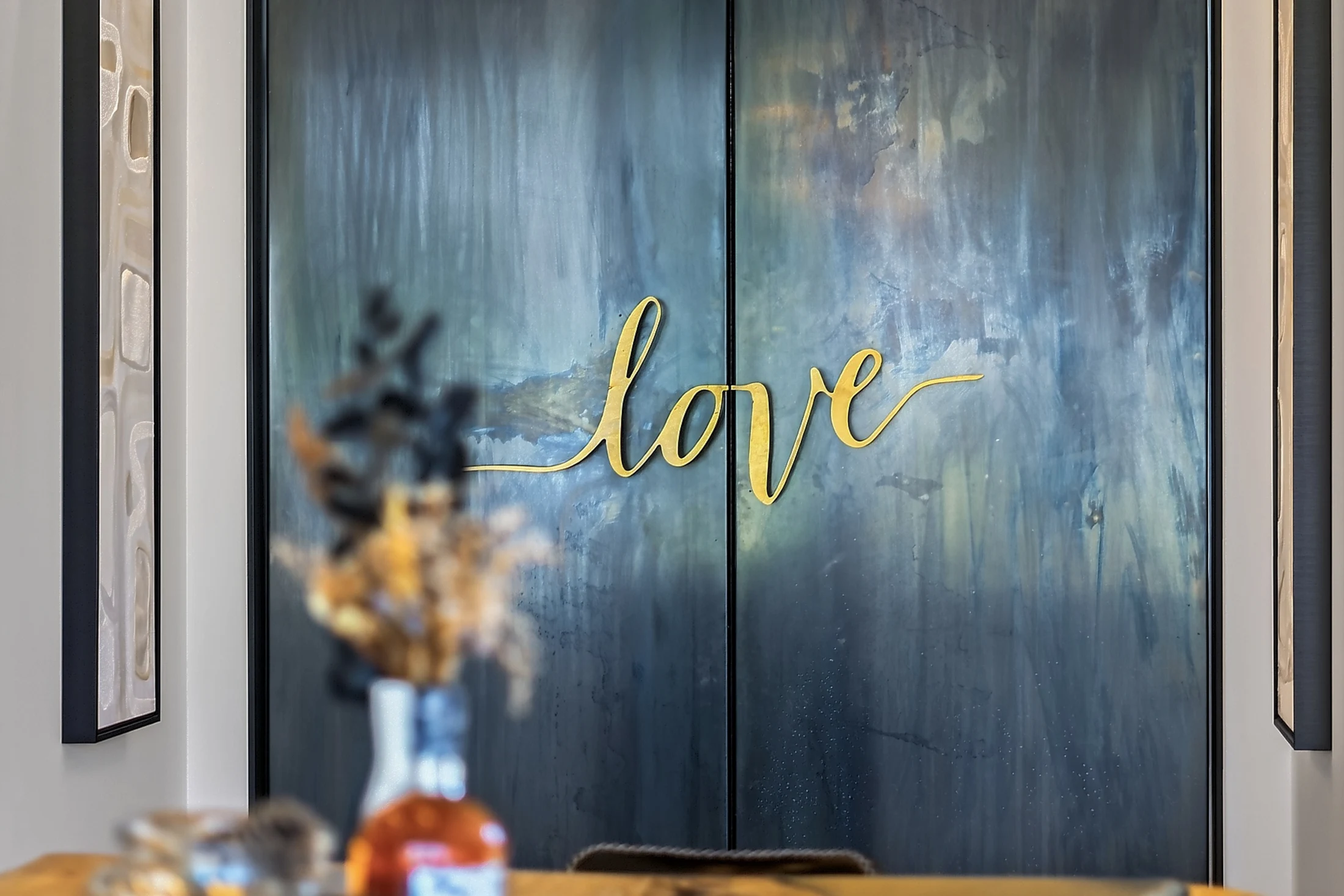 The Love Room: custom steel doors with sculptural brass lettering