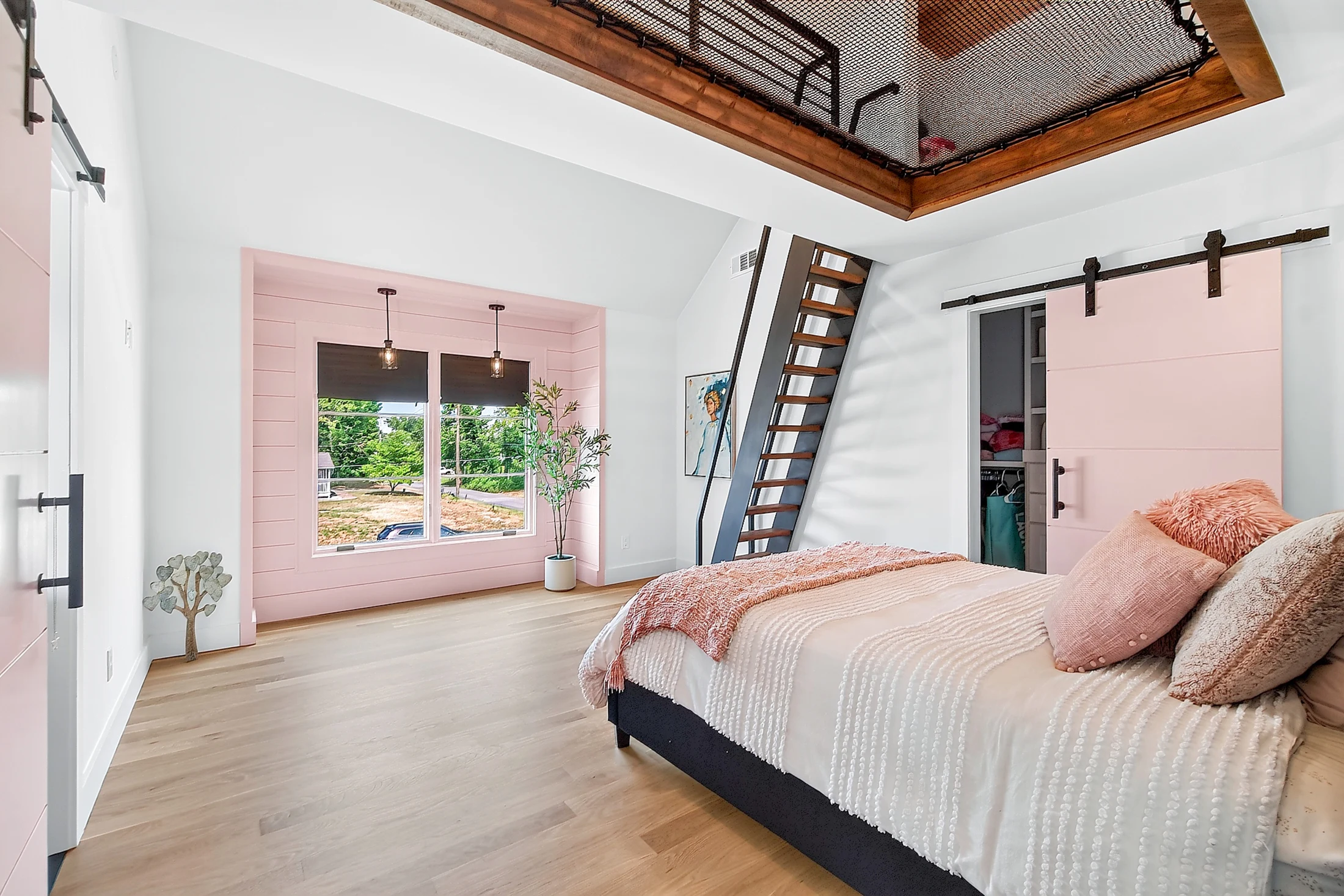 An upstairs bedroom with ladder and elevated net