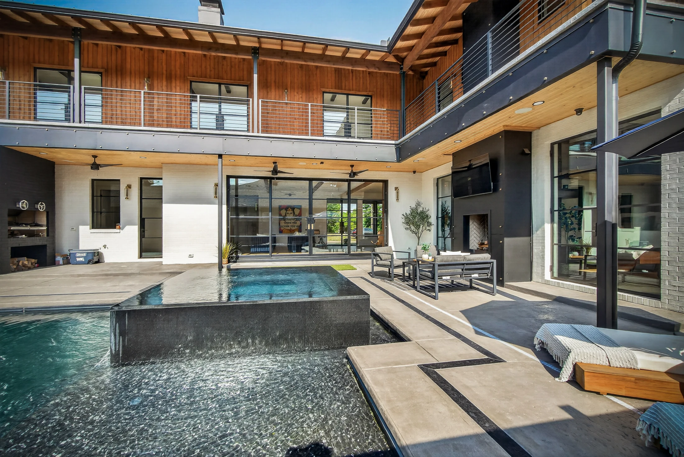 The pool and infinity spa beside the open great room