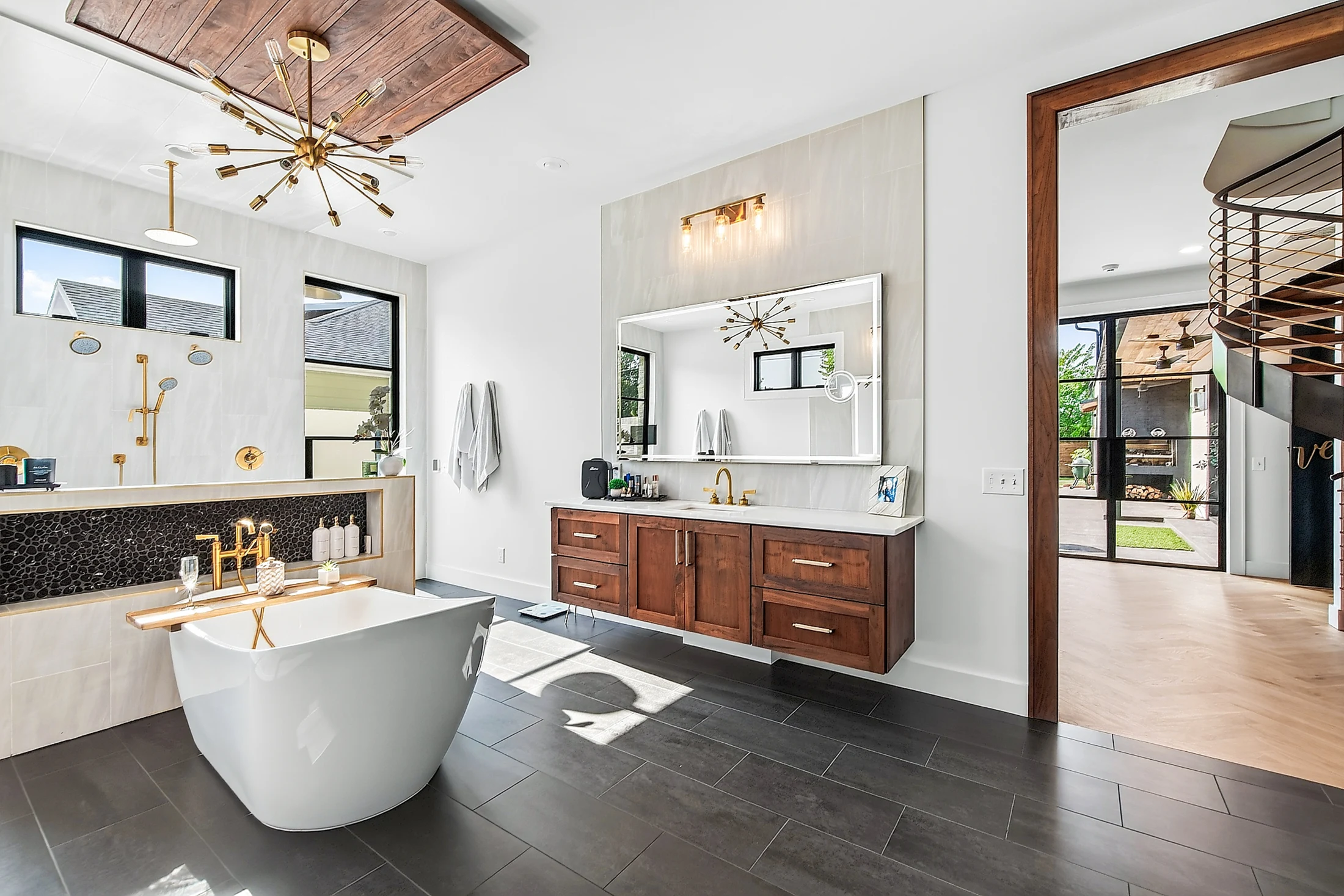 The primary bath with freestanding tub and abundant light