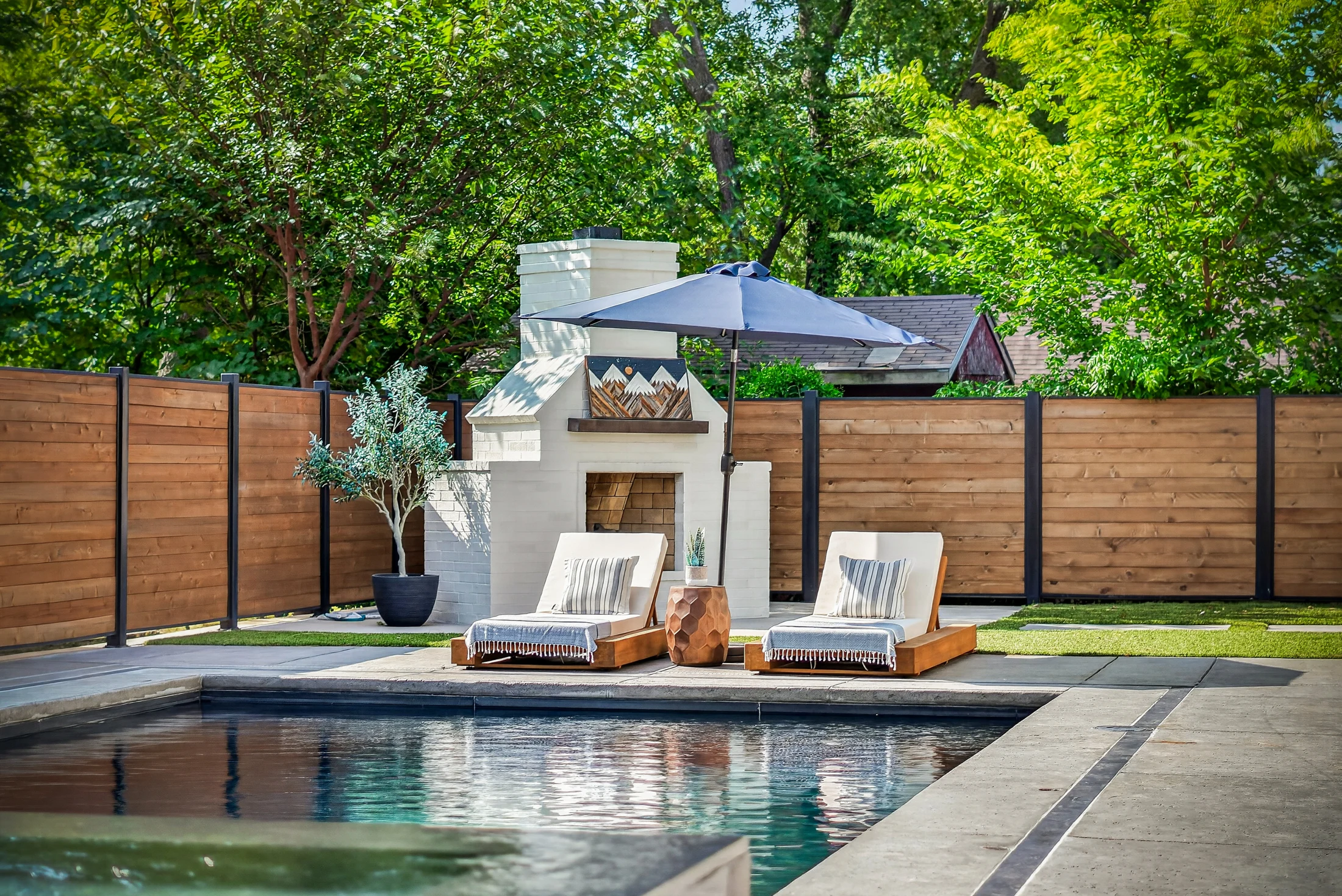 The poolside fireplace and landscape