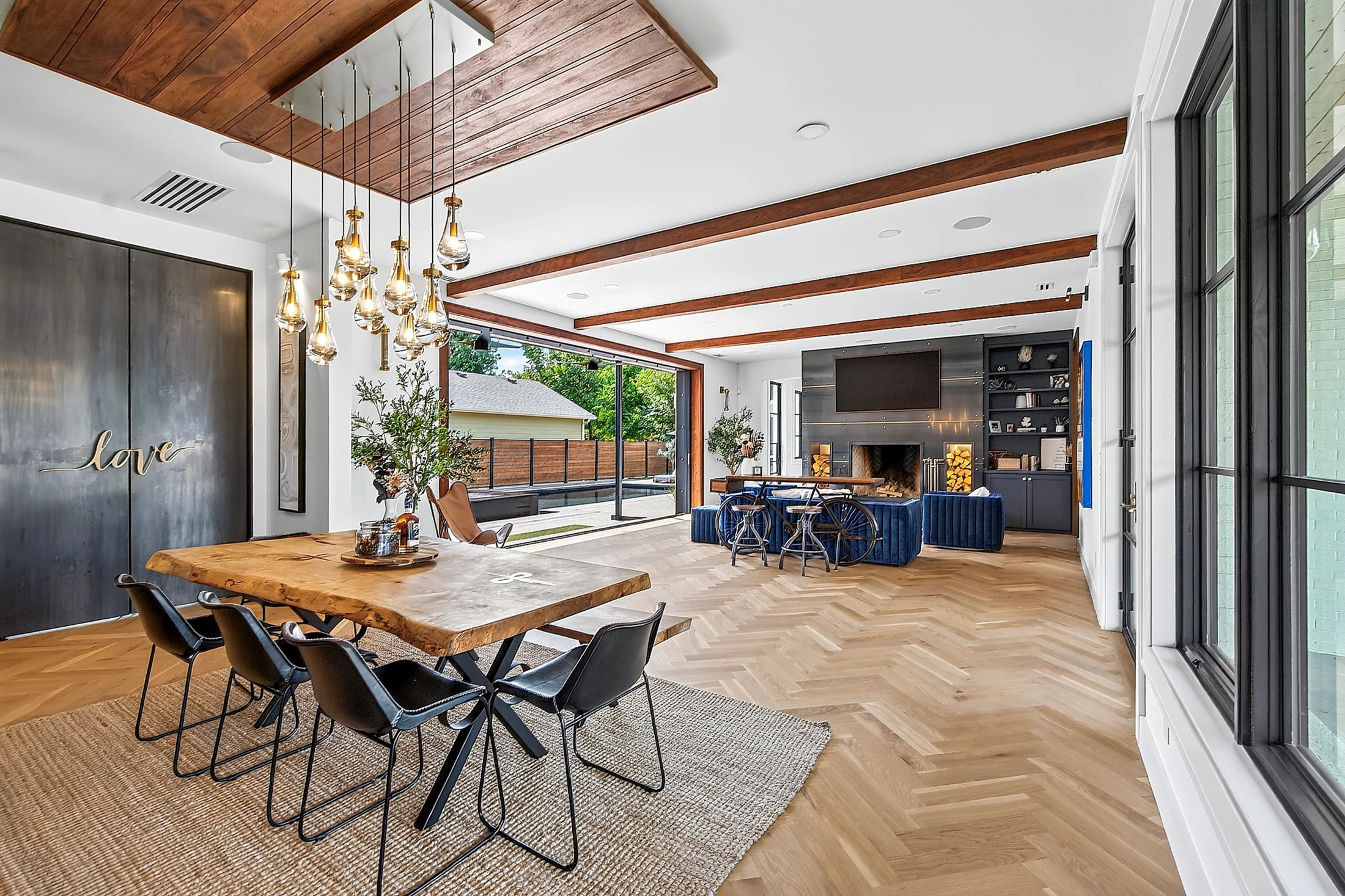 Dining beneath walnut beams beside the pool